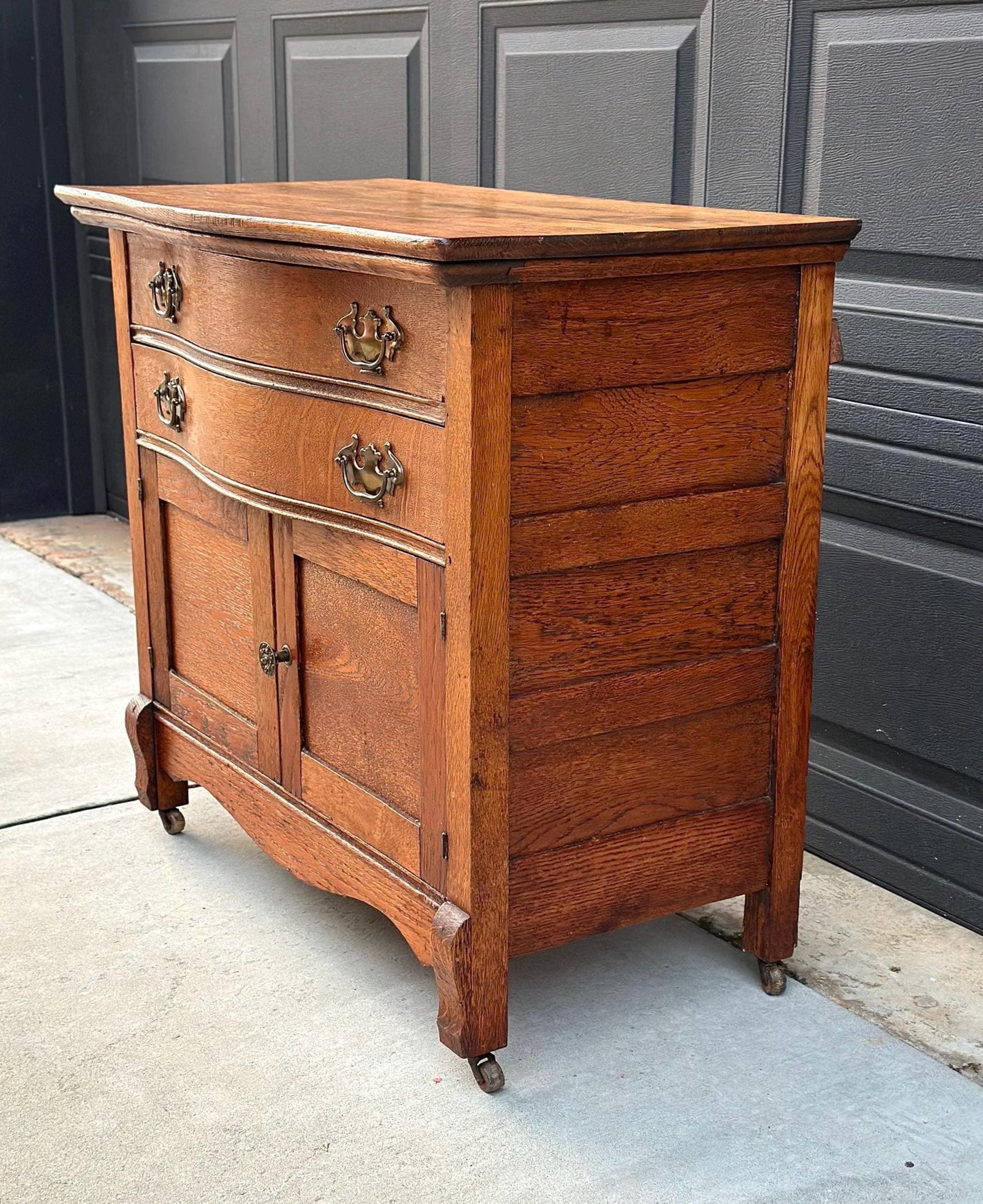 Antique Early 1900's Solid Wood Tiger Oak Curved Front Accent Cabinet on Casters