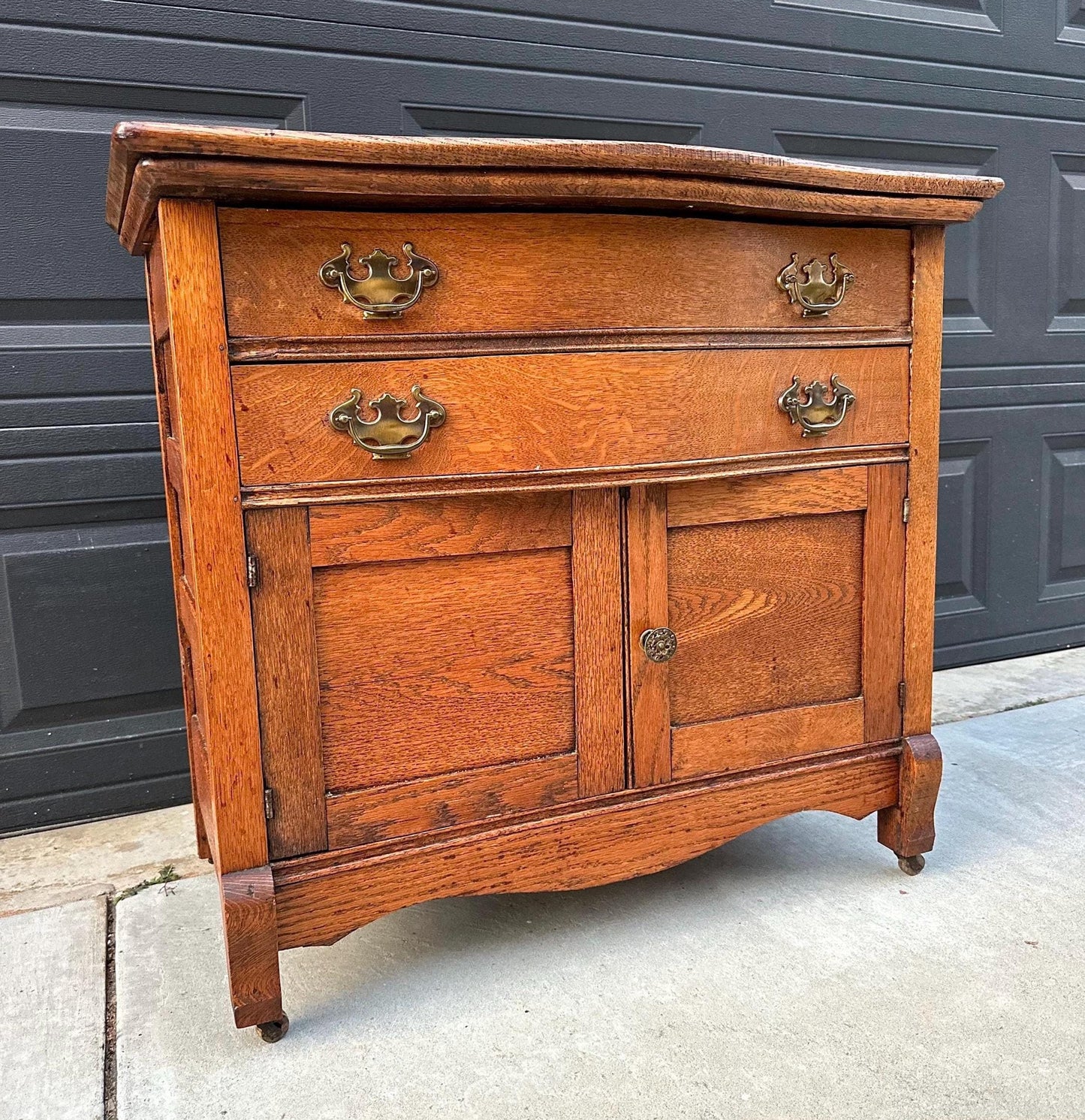 Antique Early 1900's Solid Wood Tiger Oak Curved Front Accent Cabinet on Casters