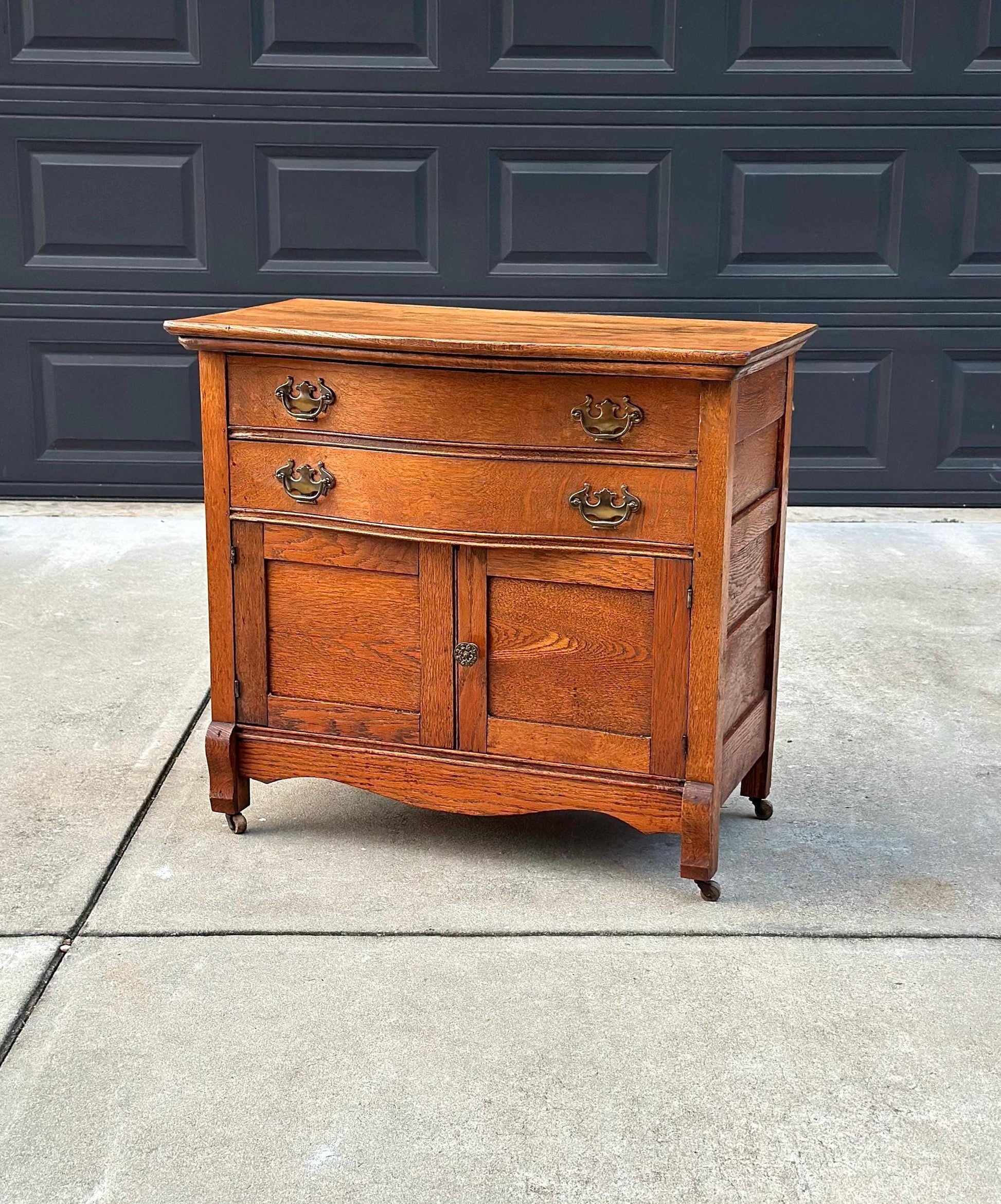 Antique Early 1900's Solid Wood Tiger Oak Curved Front Accent Cabinet on Casters