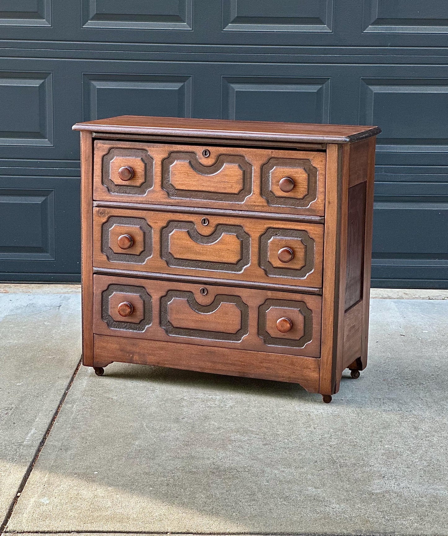 Vintage Late 19th Century Solid Wood Carved Walnut Rustic Storage Dresser on Casters